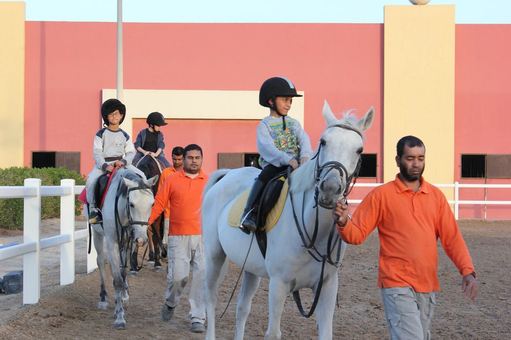 Children riding ponies led by MEC grooms