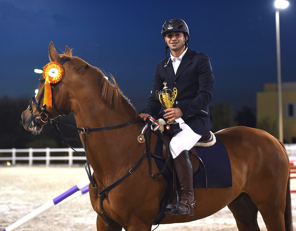 MEC rider celebrating a competition win with trophy and rosette